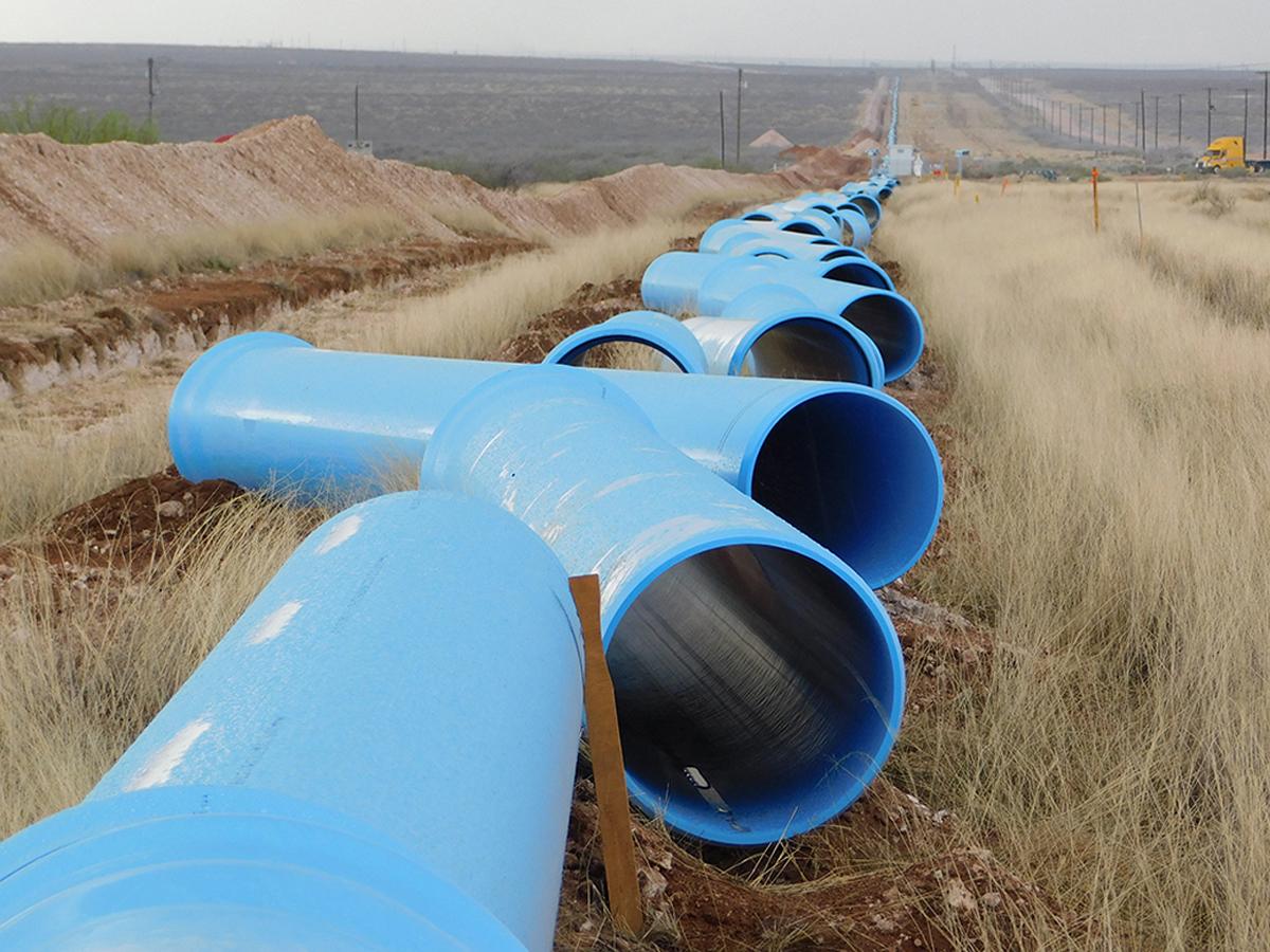 Large diameter blue pipe in field